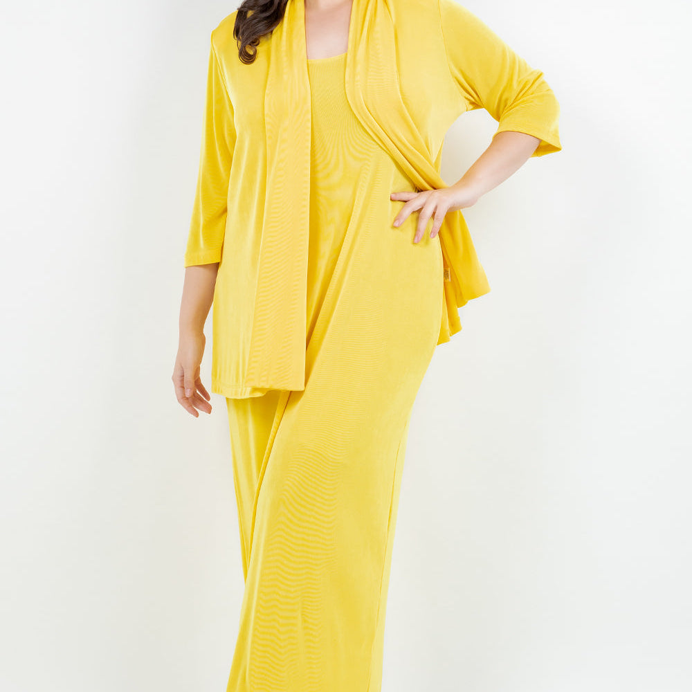 Woman wearing a yellow outfit with a matching jacket on a white background