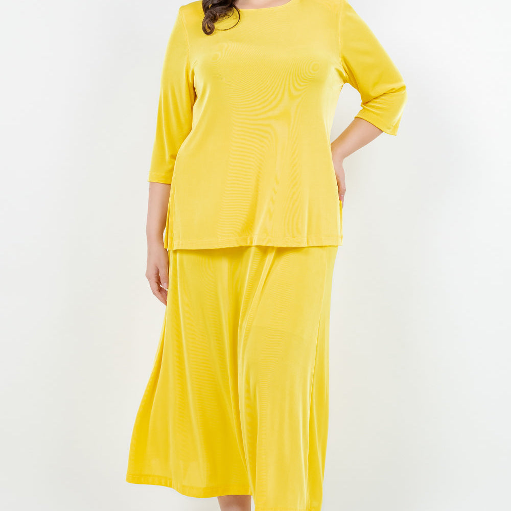Woman wearing a yellow outfit on a white background
