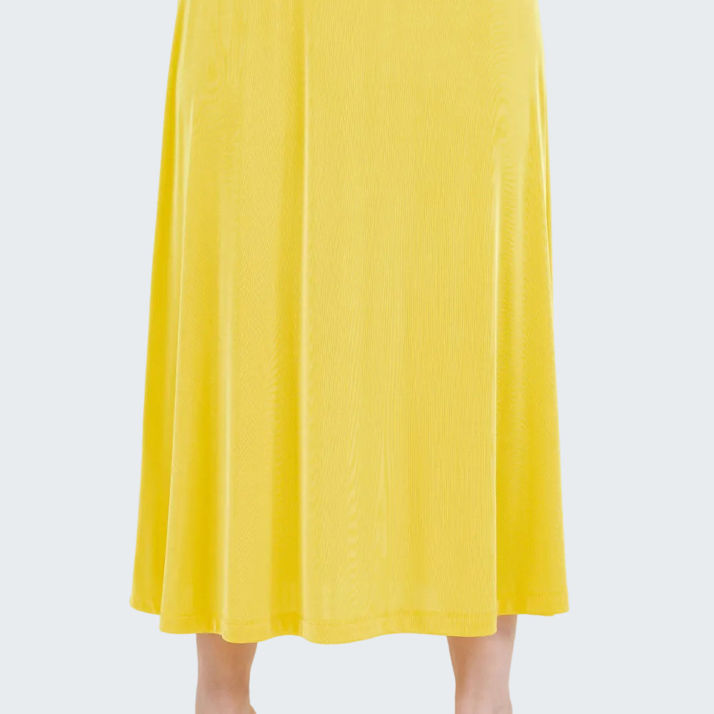 Yellow skirt worn by a person on a white background