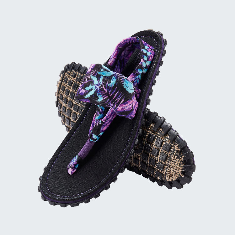 Pair of sandals with floral patterned straps on a white background