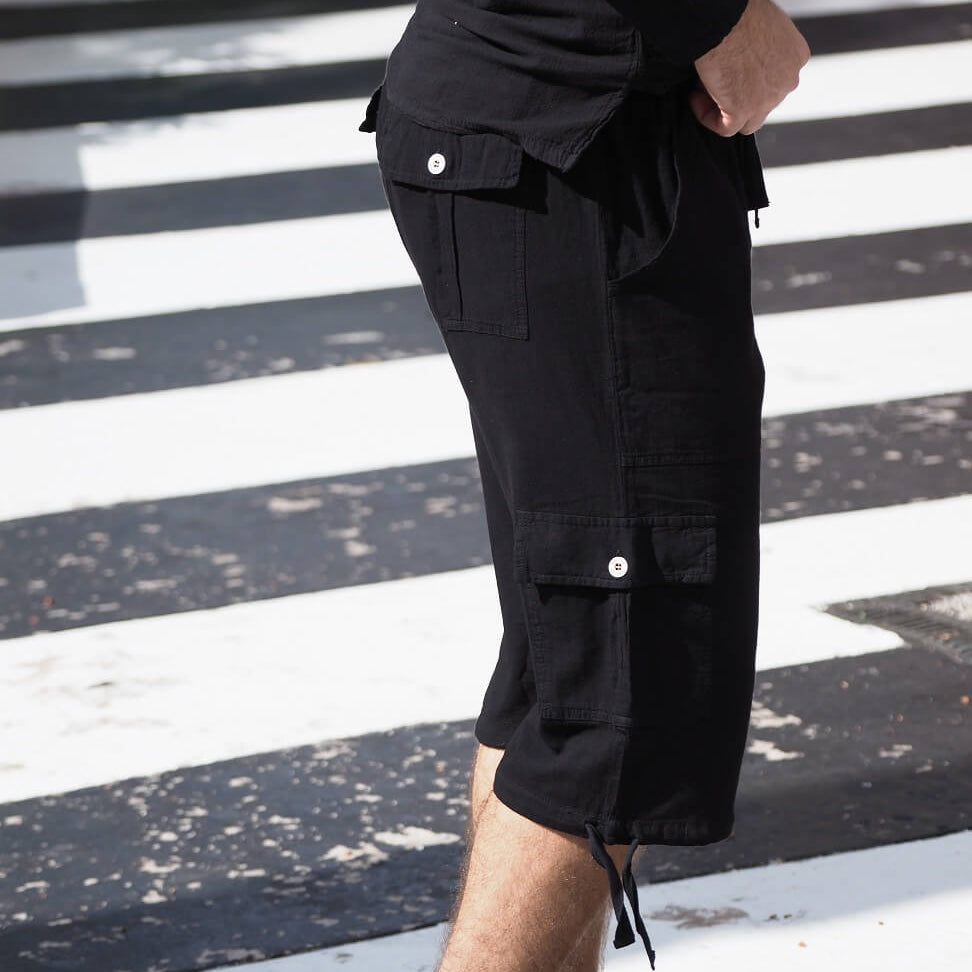 Person wearing black cargo shorts on a zebra crossing