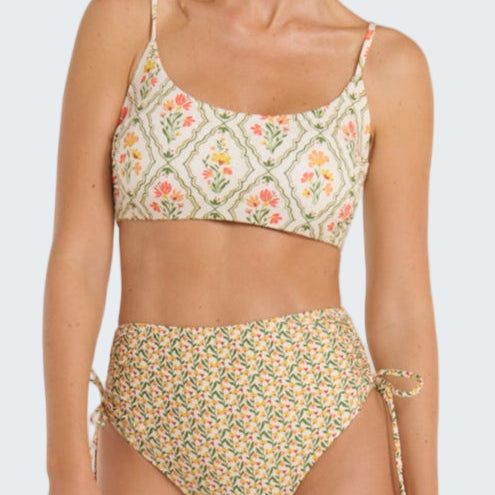 Woman wearing a floral bikini set on a white background