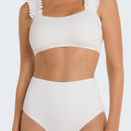White bikini with ruffled straps on a white background