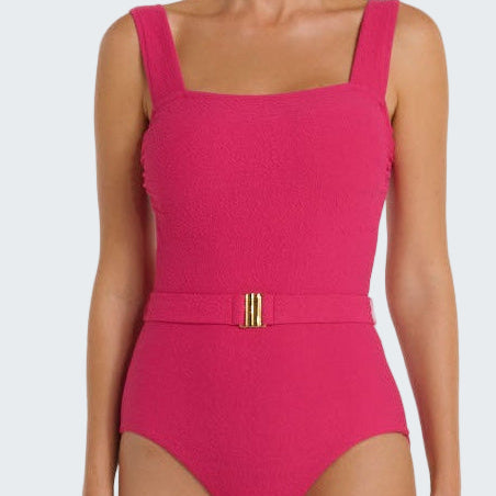 Pink swimsuit with a gold belt on a white background