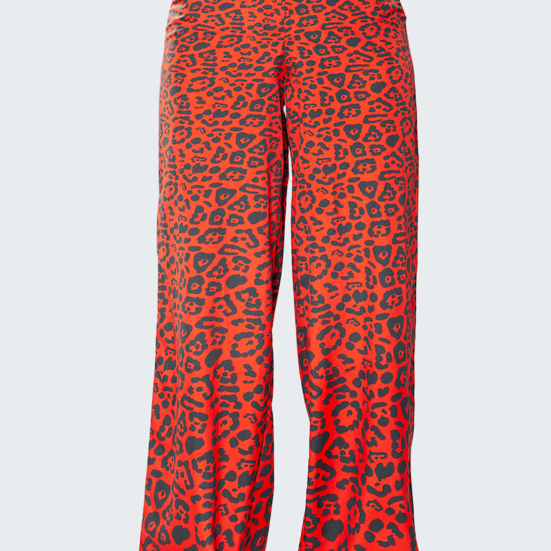 Red leopard print pants with gold trim on a white background