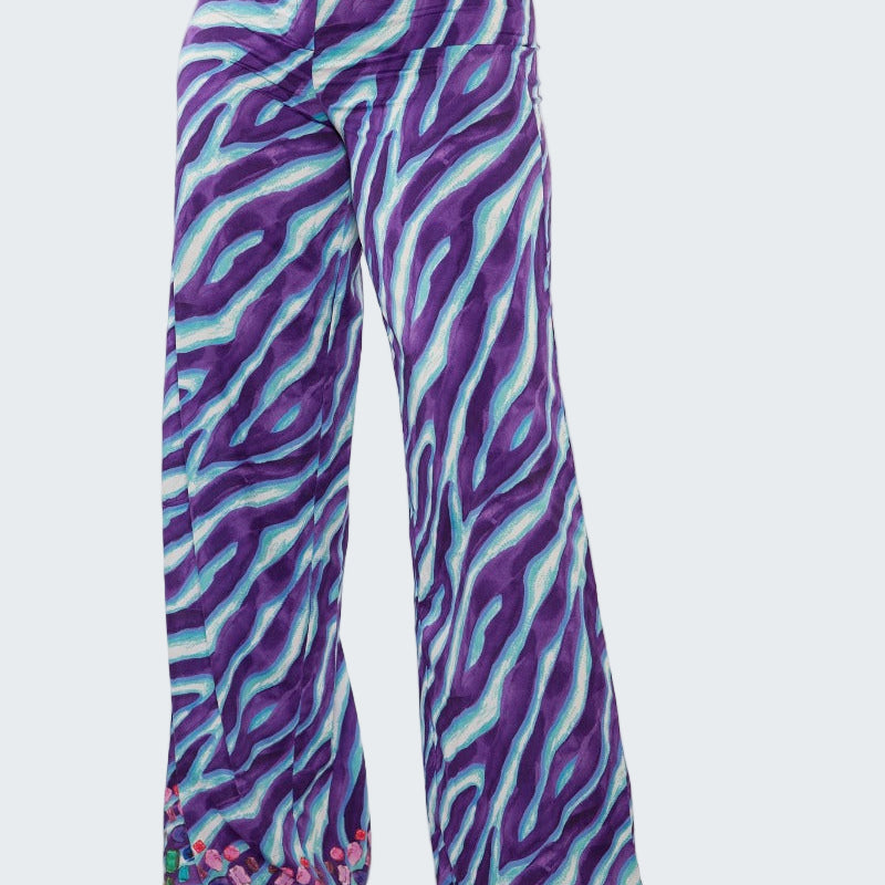 Purple and blue zebra print pants on a white background