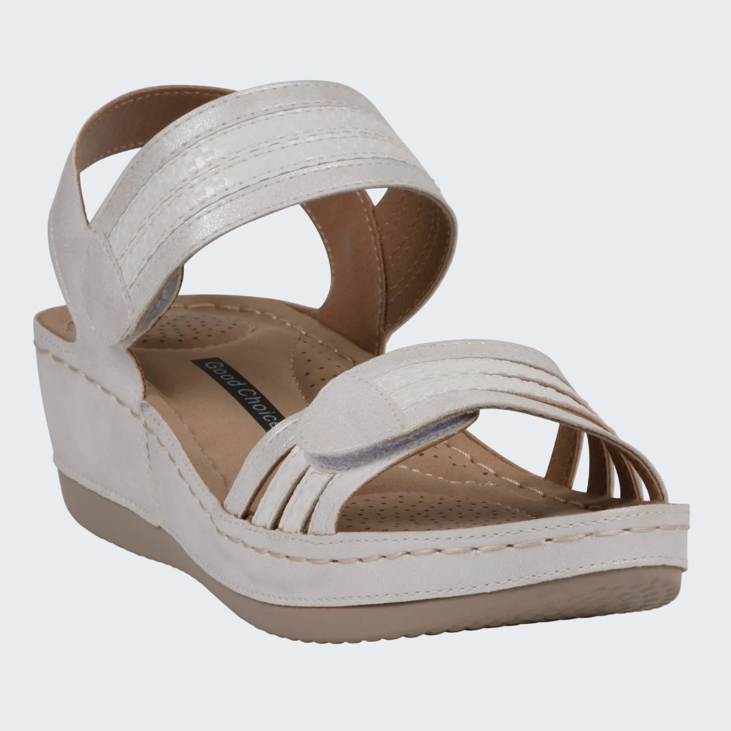 White wedge sandal with brown insole on a white background