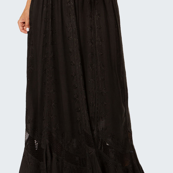Black long skirt worn by a person on a white background