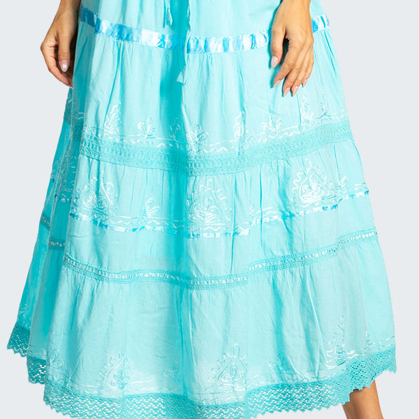 Light blue lace skirt worn by a person on a white background