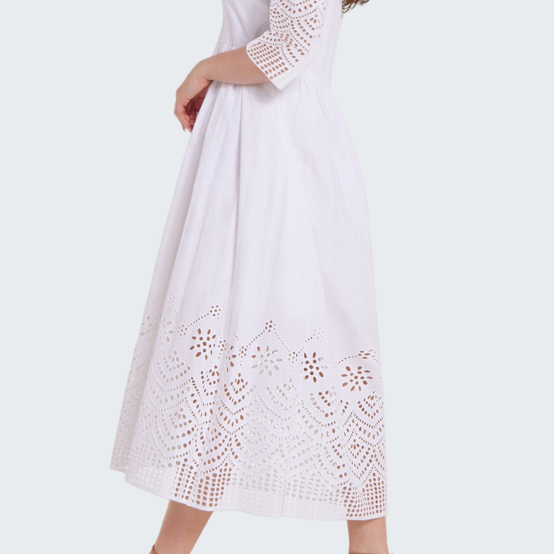 White lace dress worn by a model on a white background
