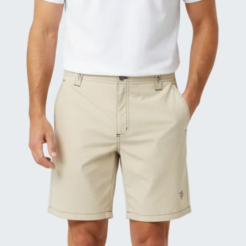 Beige shorts worn by a person on a white background