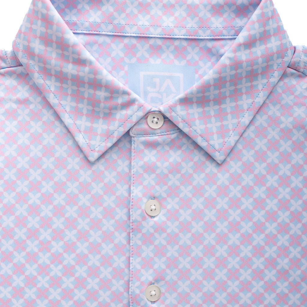 Close-up of a light blue and pink checkered polo shirt with buttons.