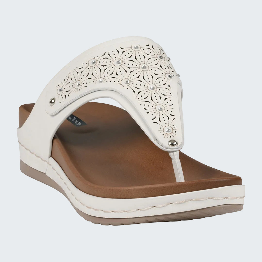 White sandal with floral design on a white background