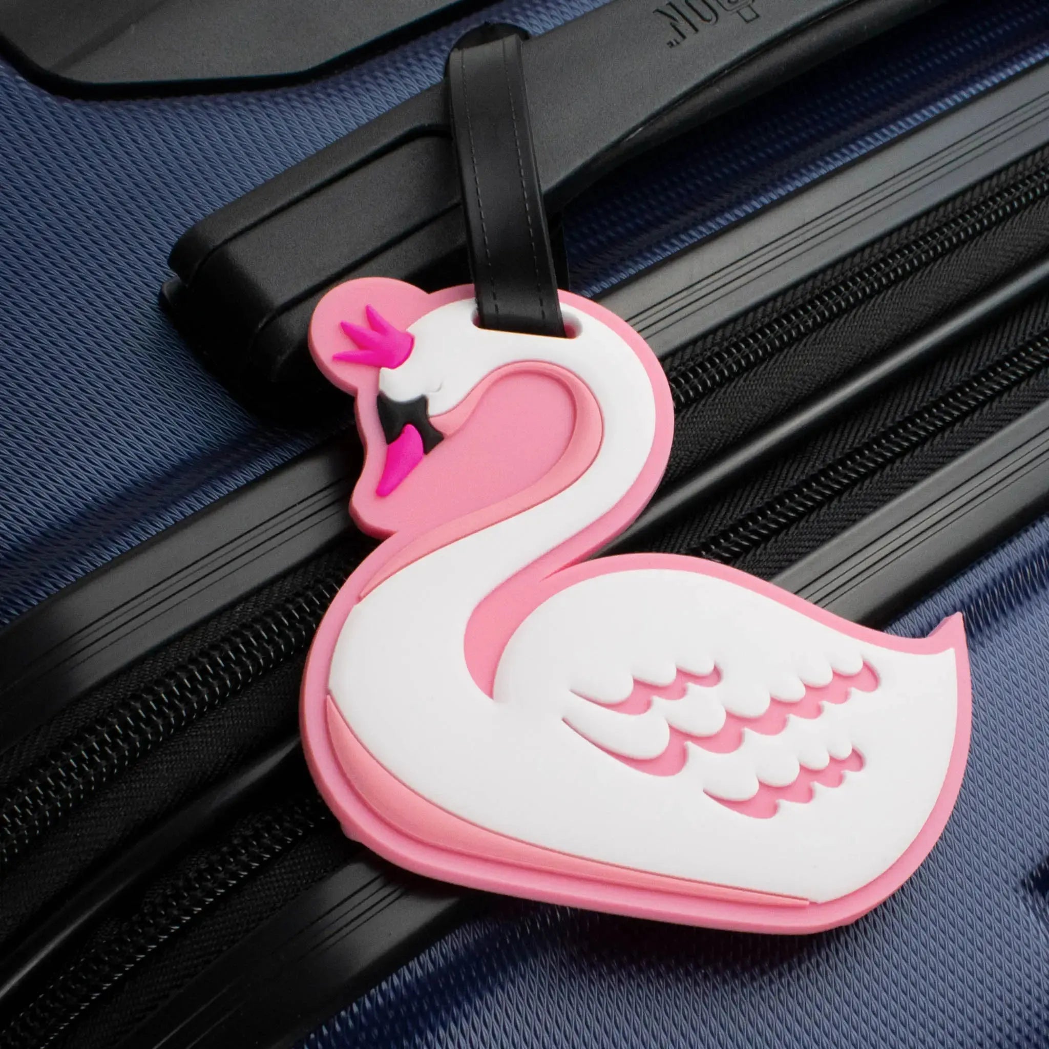 Pink flamingo-shaped luggage tag attached to a blue suitcase.