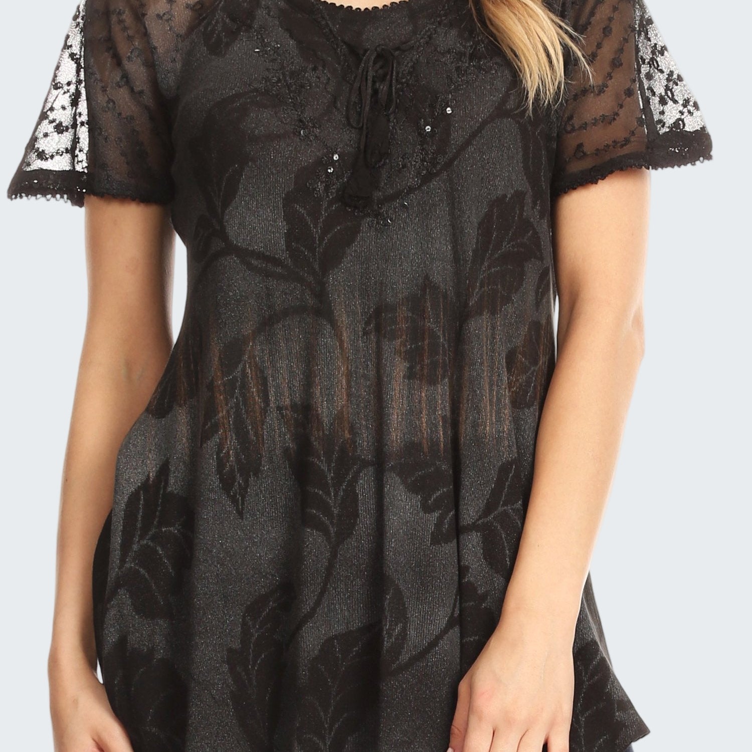 Black lace top worn by a model on a white background