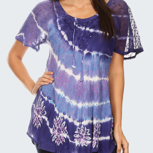 Woman wearing a purple tie-dye shirt with floral patterns on a white background