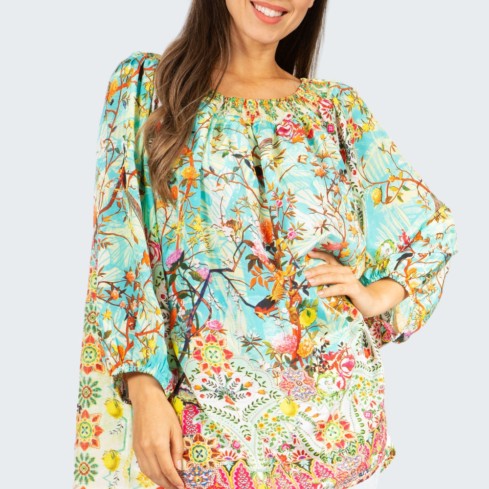 Woman wearing a colorful floral blouse with a white background