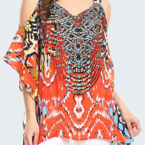 Woman wearing a colorful patterned top with a white background