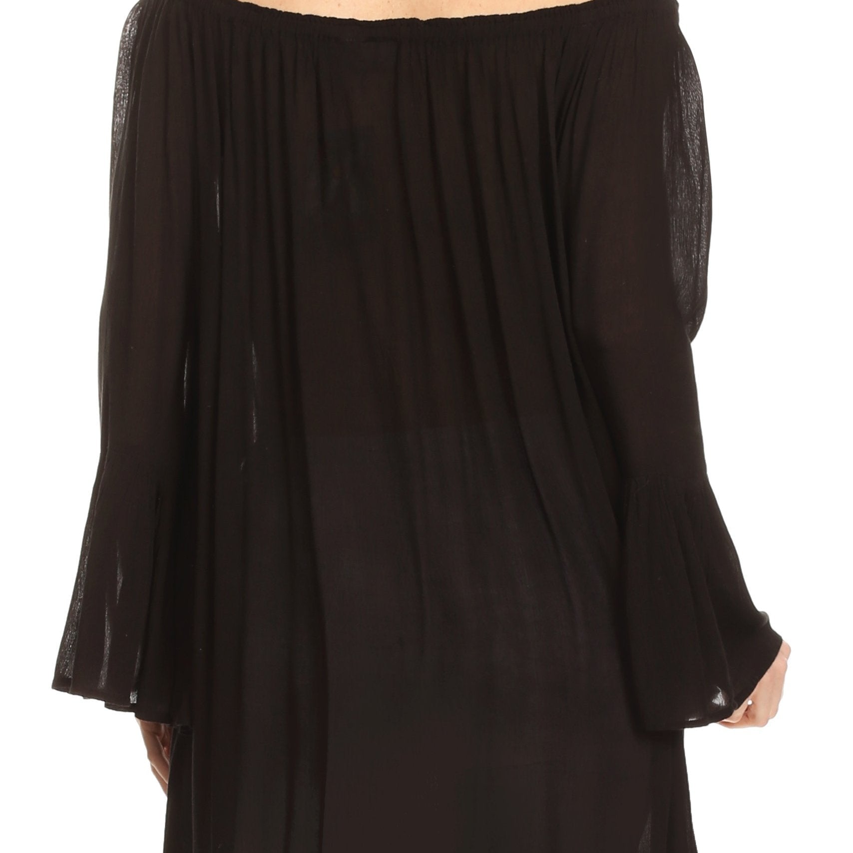 Black off-shoulder top worn by a person on a white background