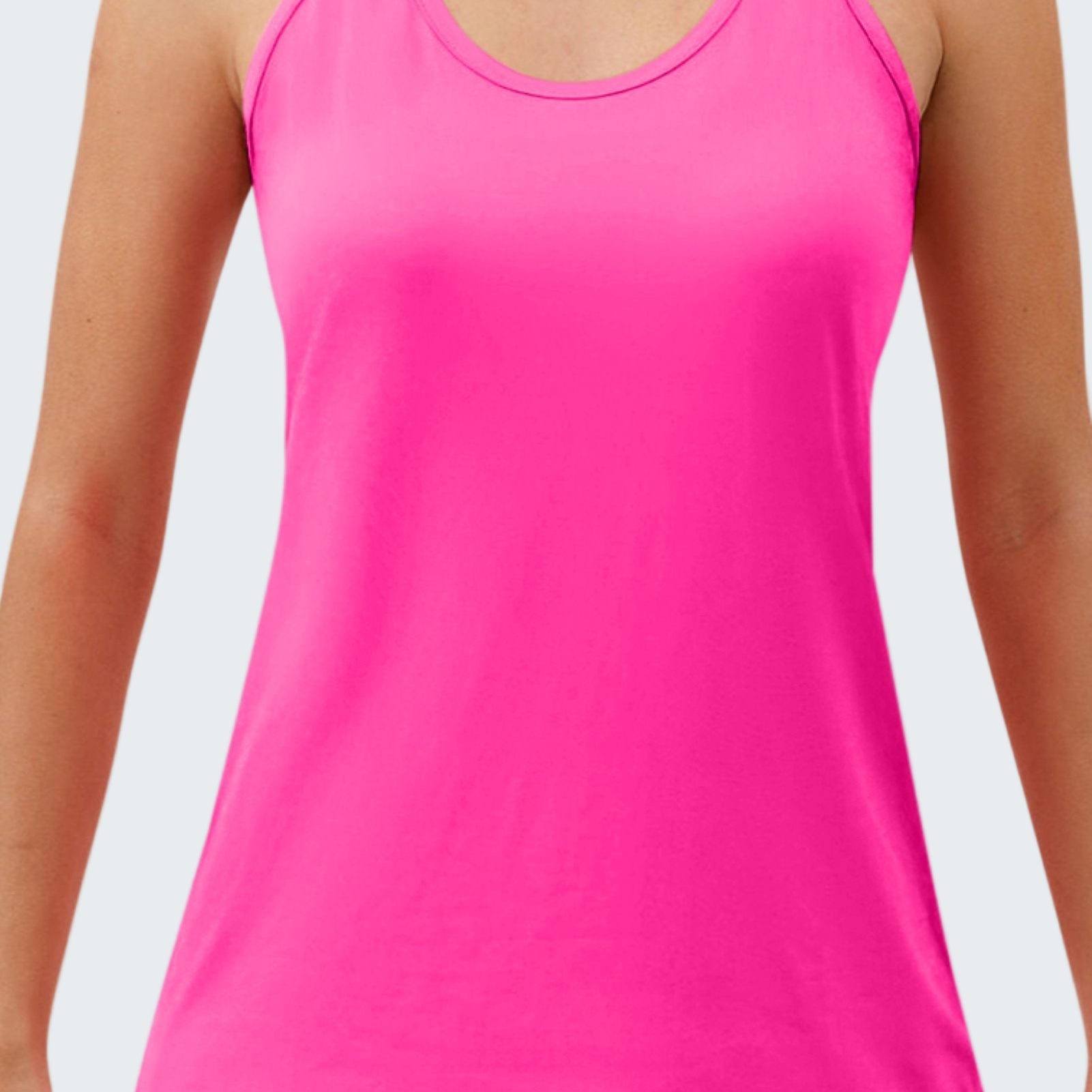 Pink tank top worn by a person on a white background