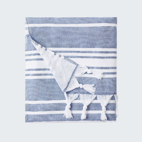 Blue and white striped towel with tassels on a white background