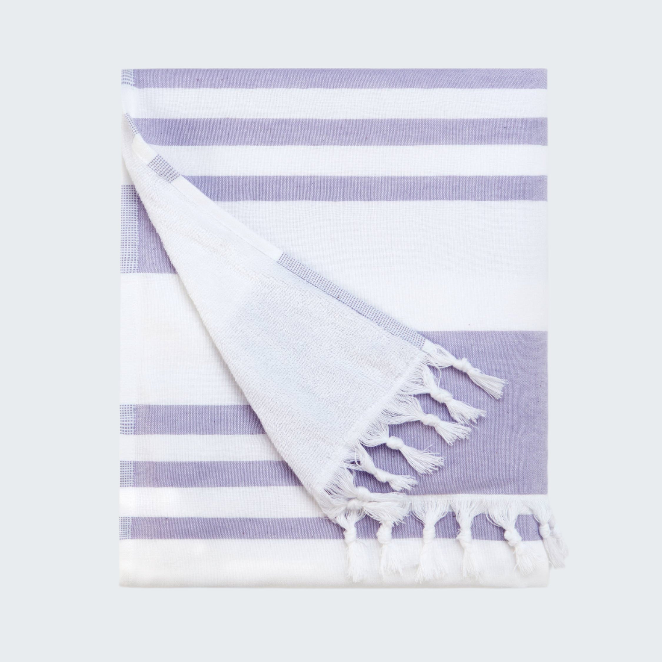 Striped towel with tassels on a white background