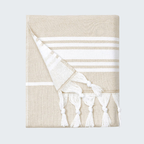 Beige towel with white stripes and tassels on a white background