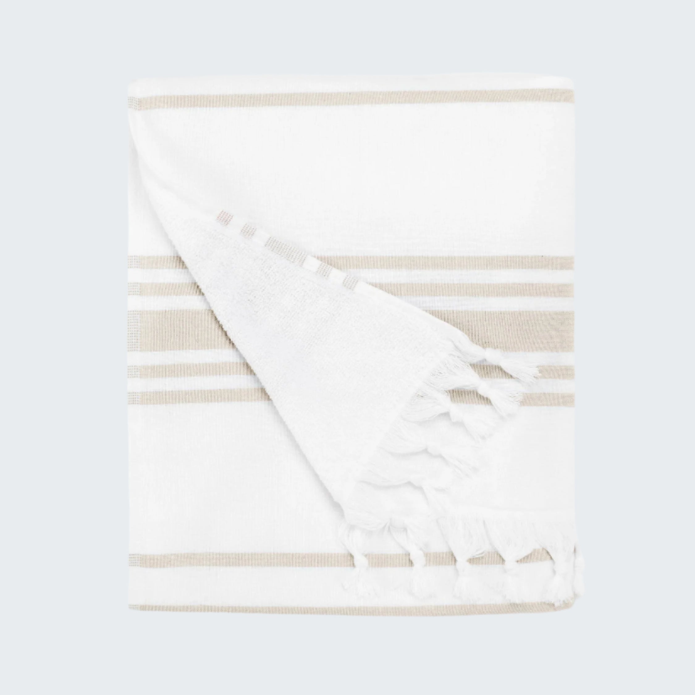 Folded white blanket with beige stripes on a white background