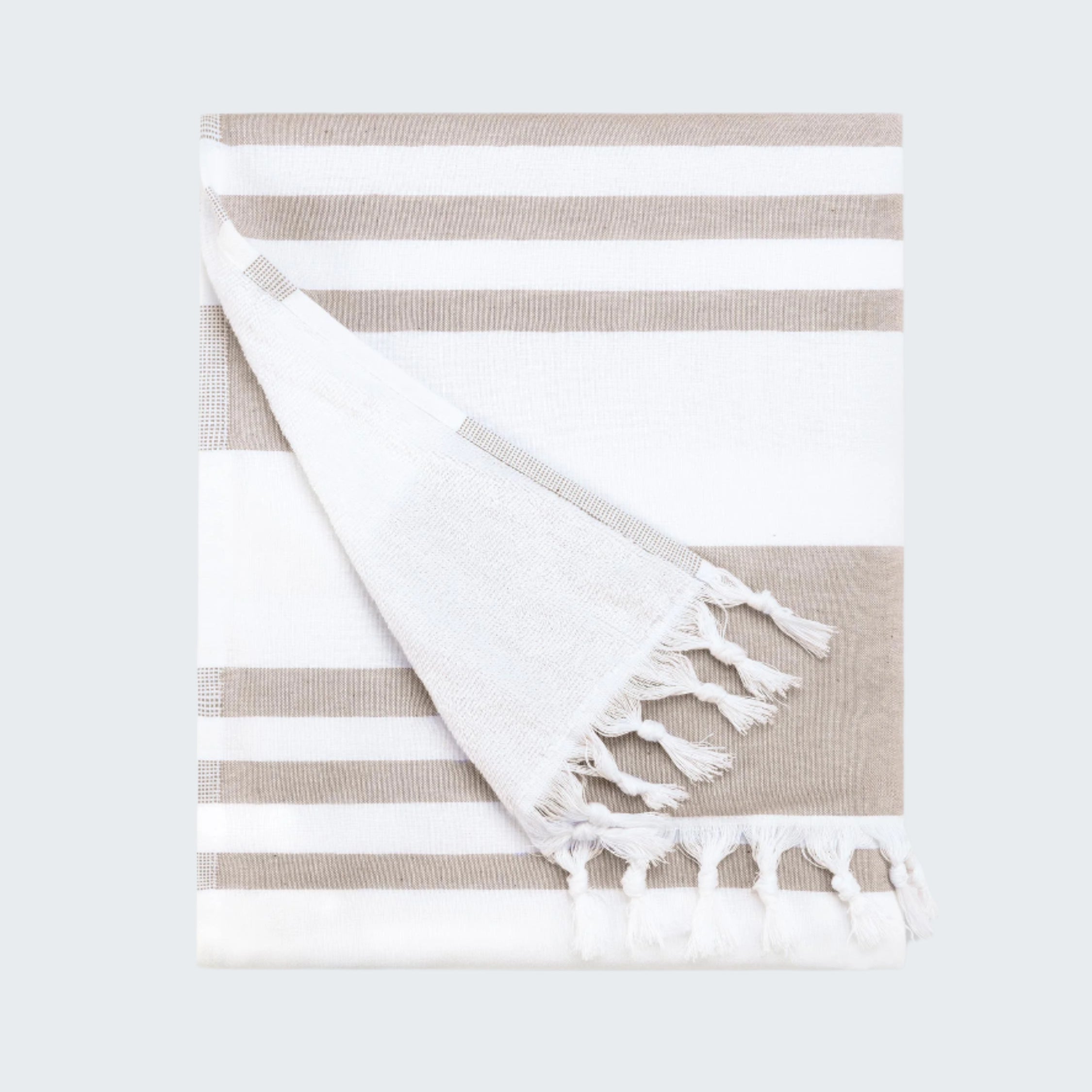Striped towel with tassels on a white background