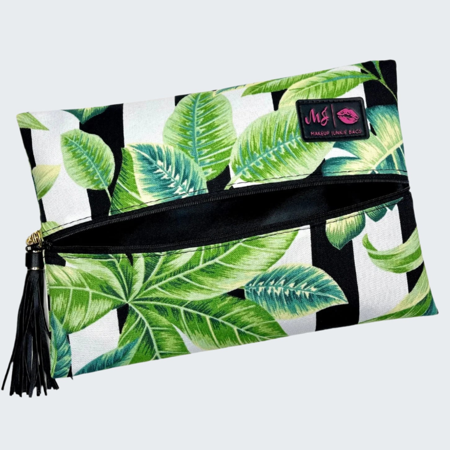 Makeup bag with tropical leaf pattern and visible brand logo on a white background