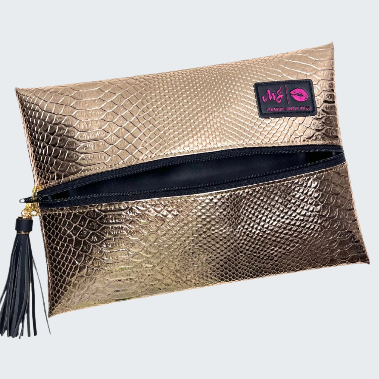Gold metallic clutch bag with a tassel on a white background