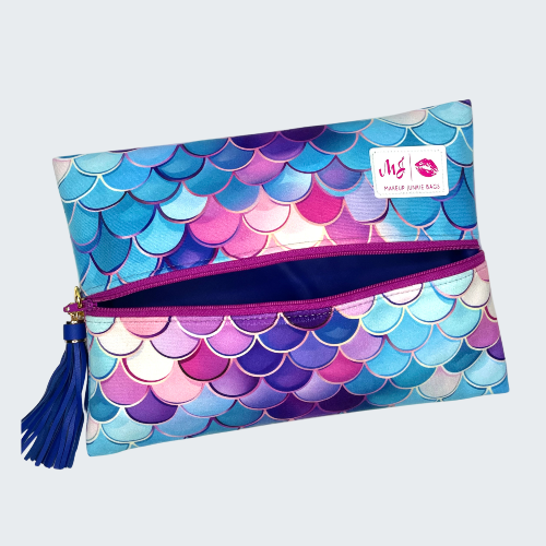 Colorful mermaid scale patterned pouch with a visible brand logo on a white background