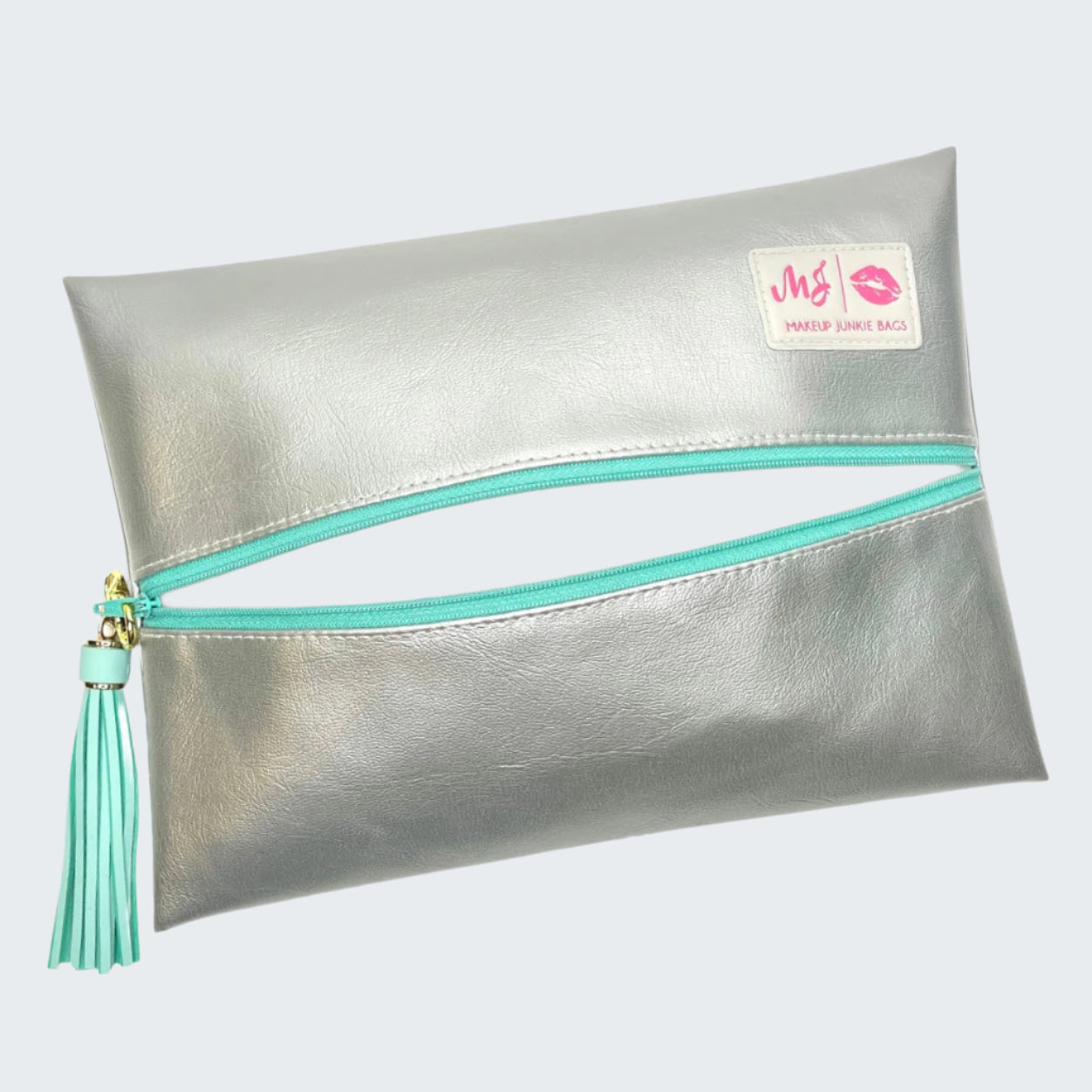 Silver makeup bag with turquoise zipper and tassel on a white background