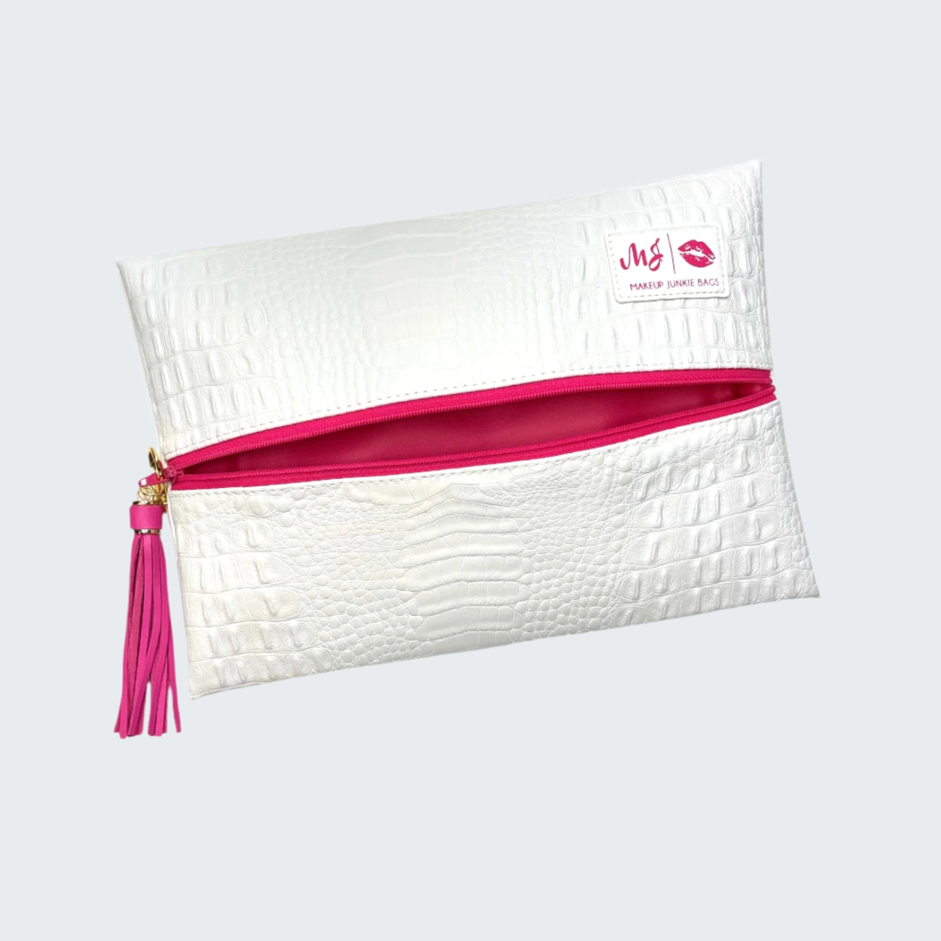 White pouch with pink interior and tassel on a white background