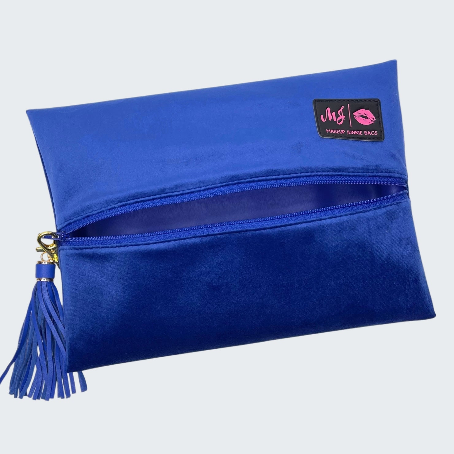 Blue clutch bag with a tassel and visible brand logo on a white background