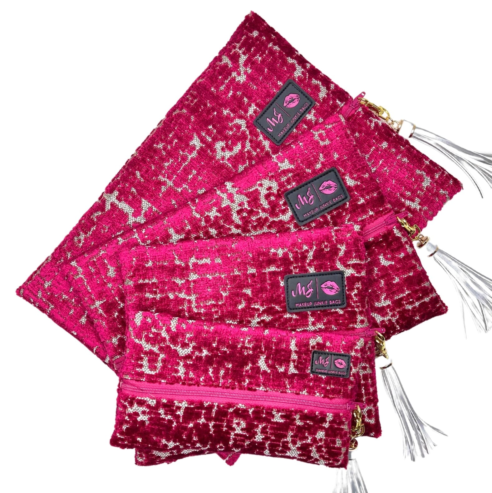 Set of pink patterned bags with visible brand labels on a white background