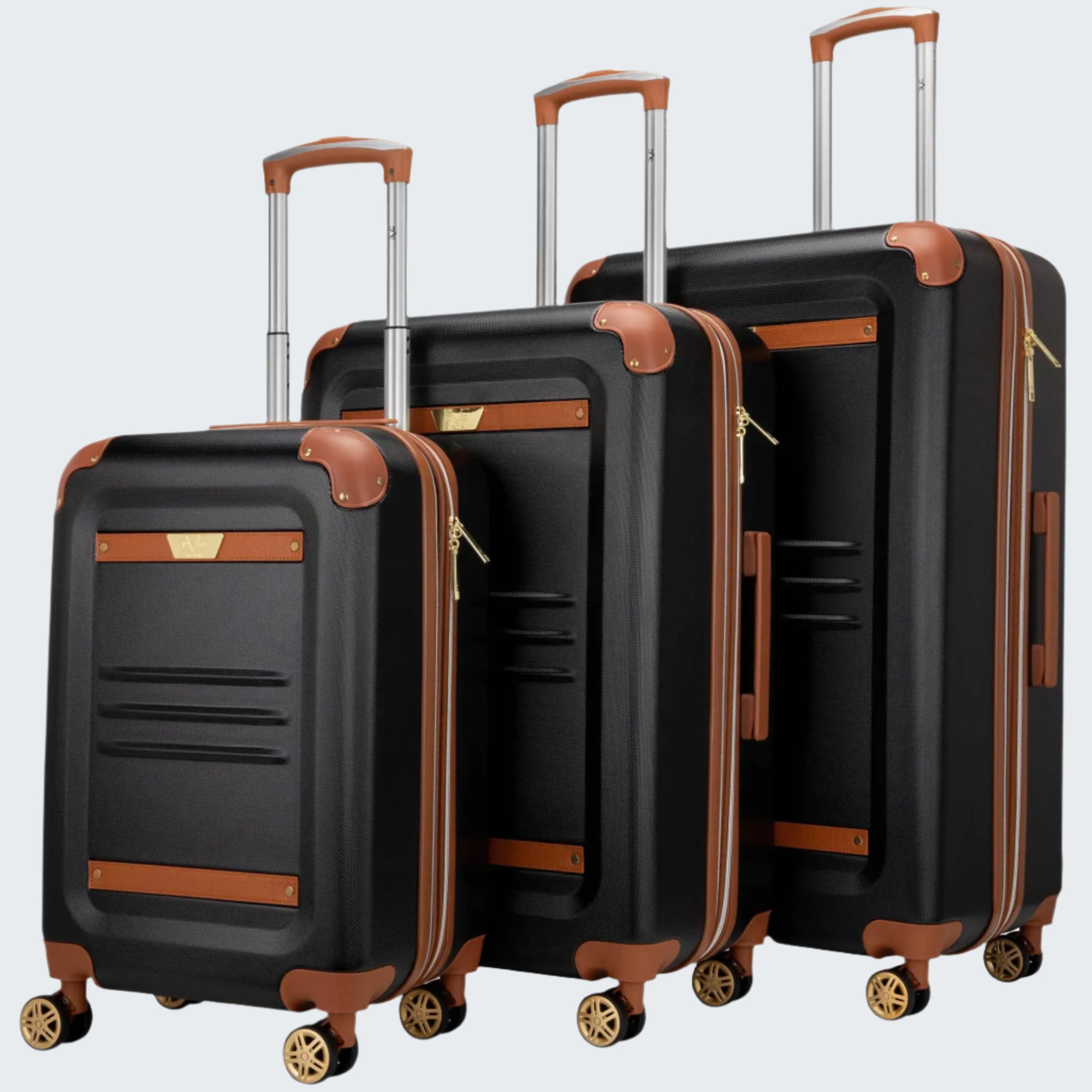 A set of three black retro-style luggage bags with brown accents and gold-colored wheels, displayed in a nested arrangement.