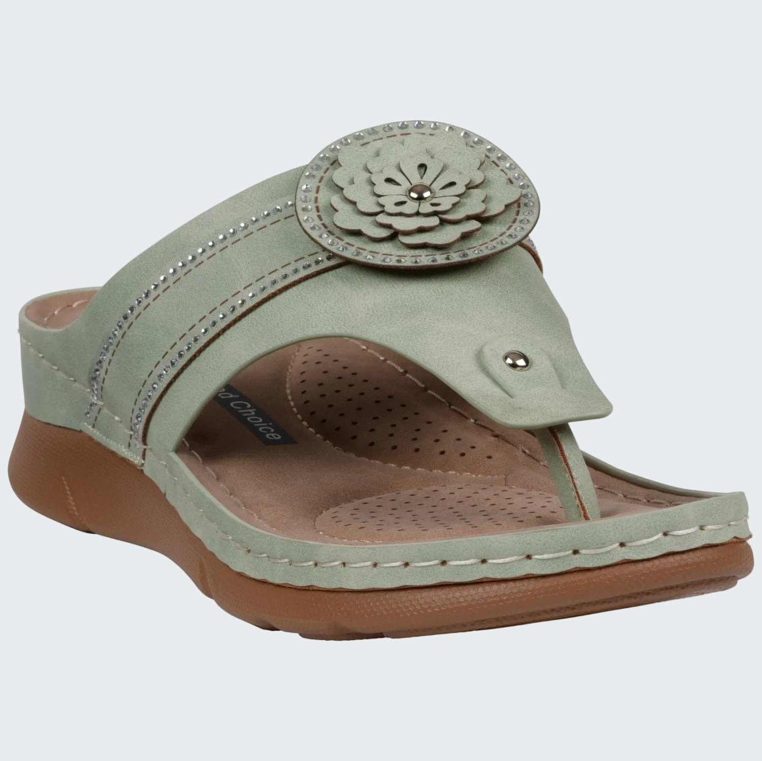 Green sandal with a floral design on a white background