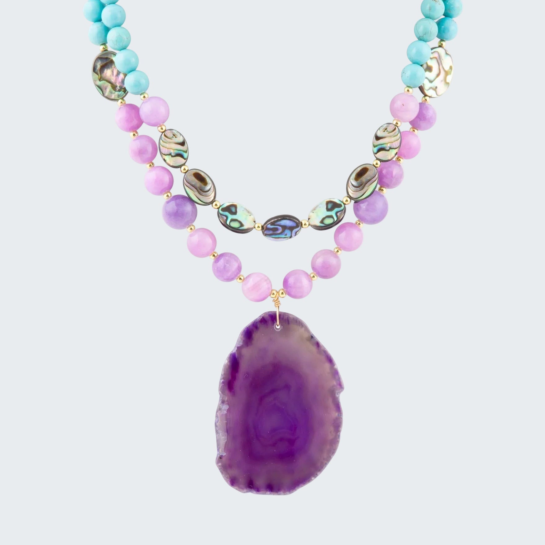 Necklace with purple agate pendant and multicolored beads on a white background