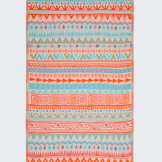 Colorful patterned towel with fringes on a white background