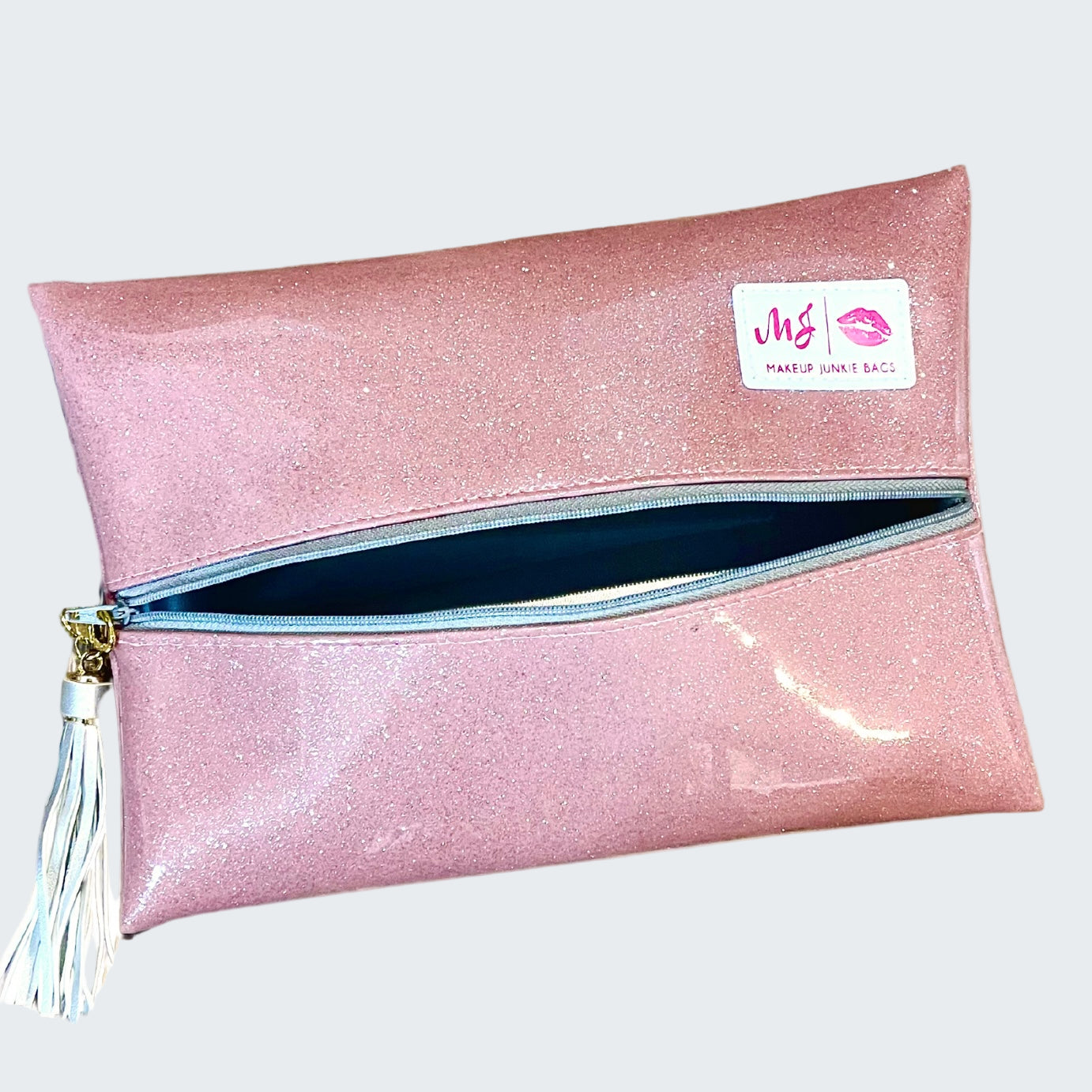 Pink glittery makeup bag with a visible brand label on a white background