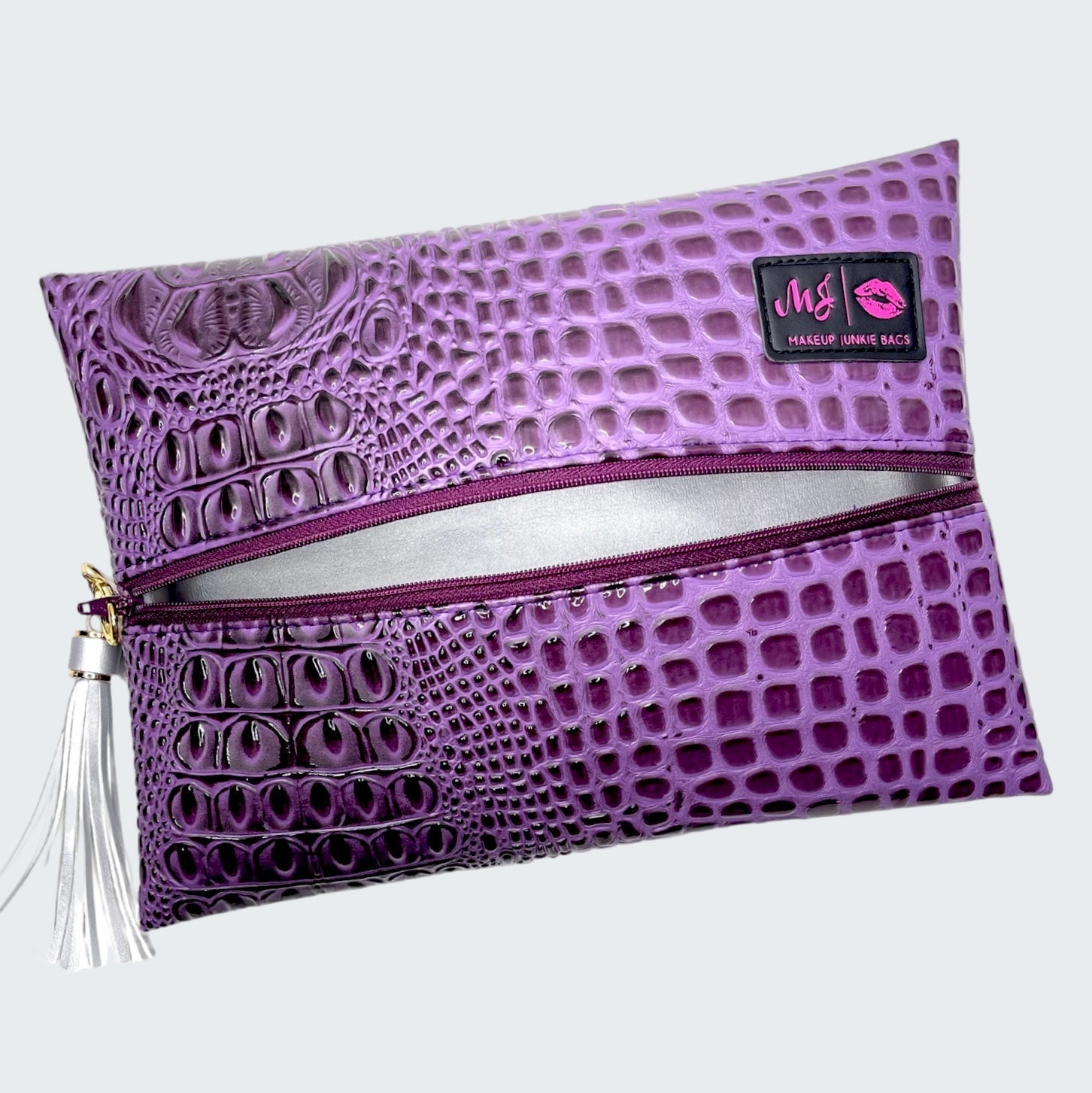 Purple textured makeup bag with a visible brand logo on a white background