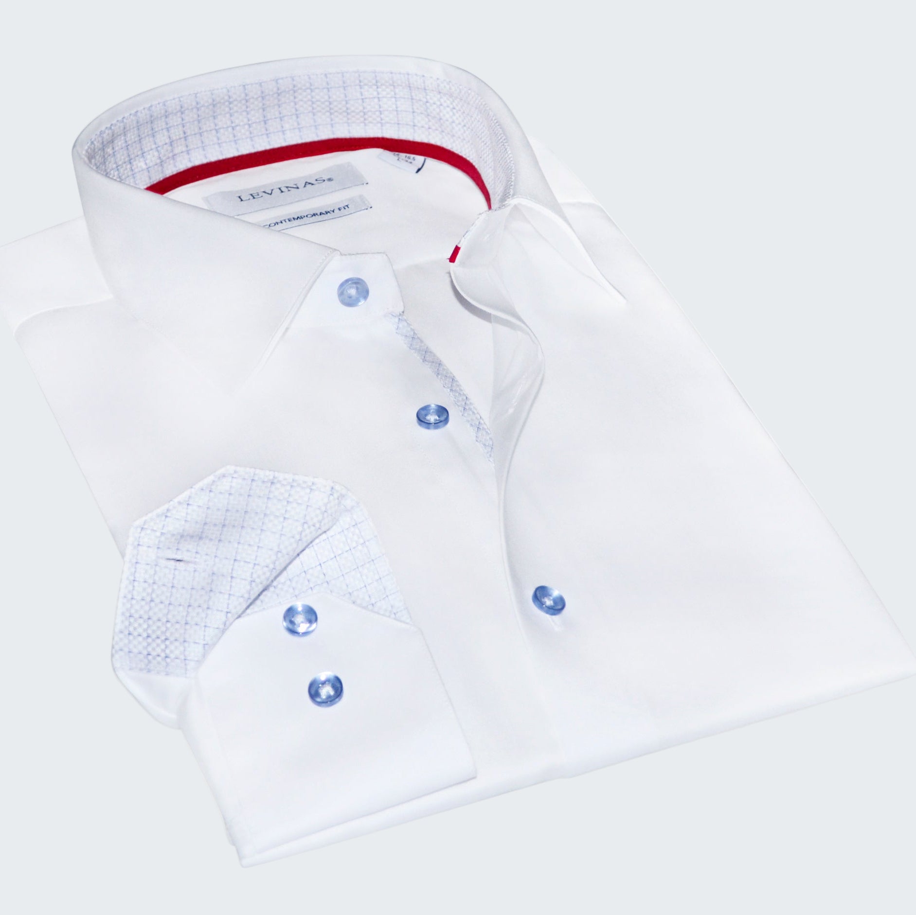 Folded white dress shirt with blue buttons on a white background