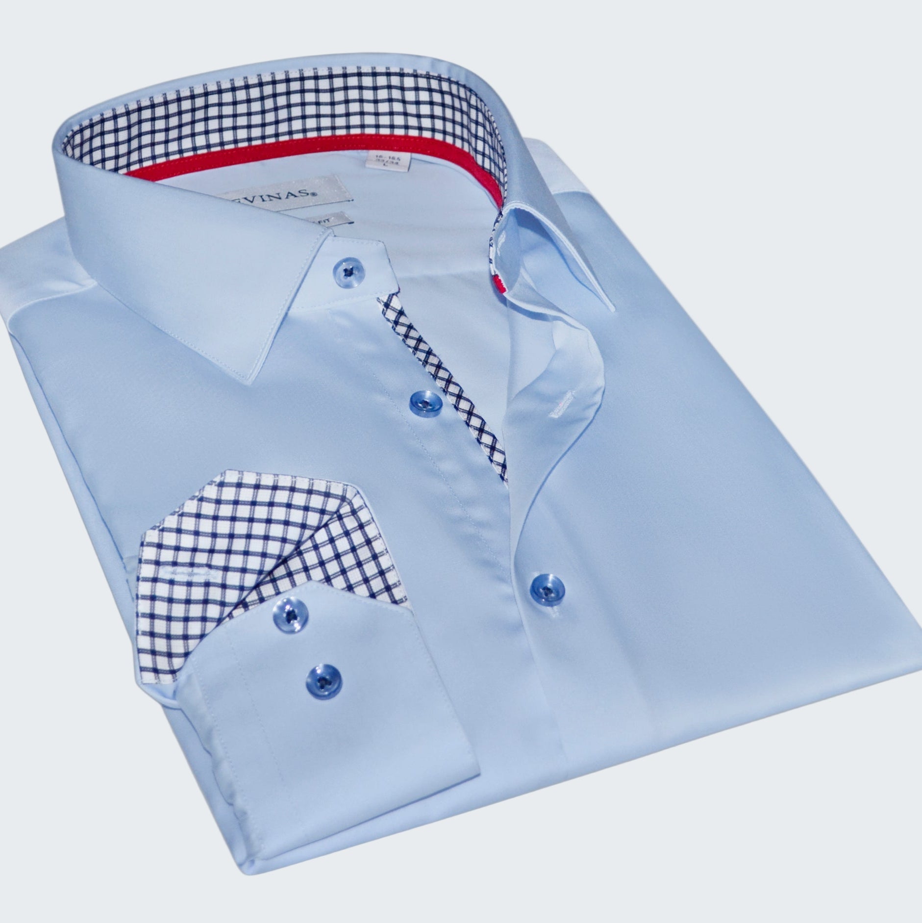 Folded light blue dress shirt with checkered details on a white background