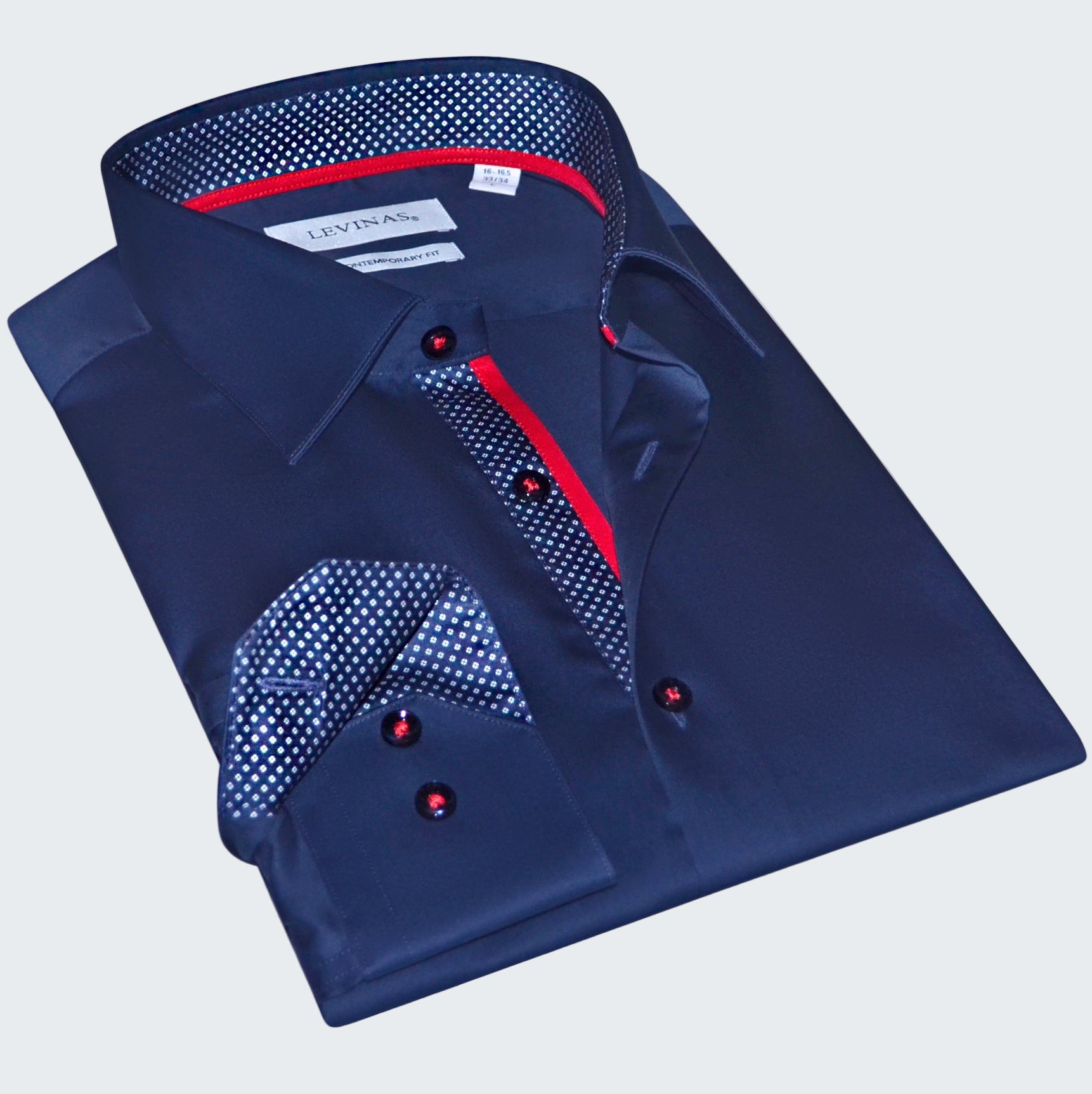 Folded blue dress shirt with red accents on a white background
