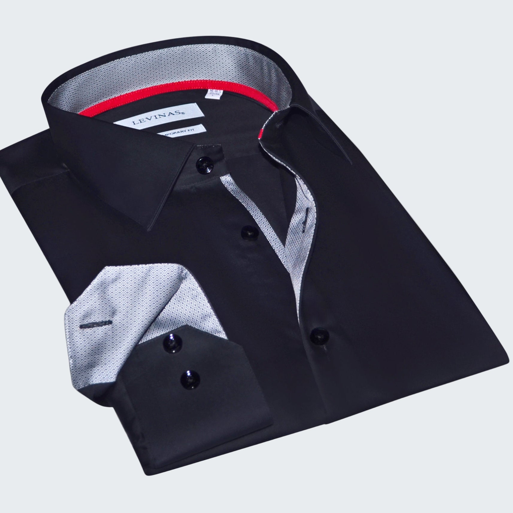 Folded black dress shirt with a gray interior on a white background