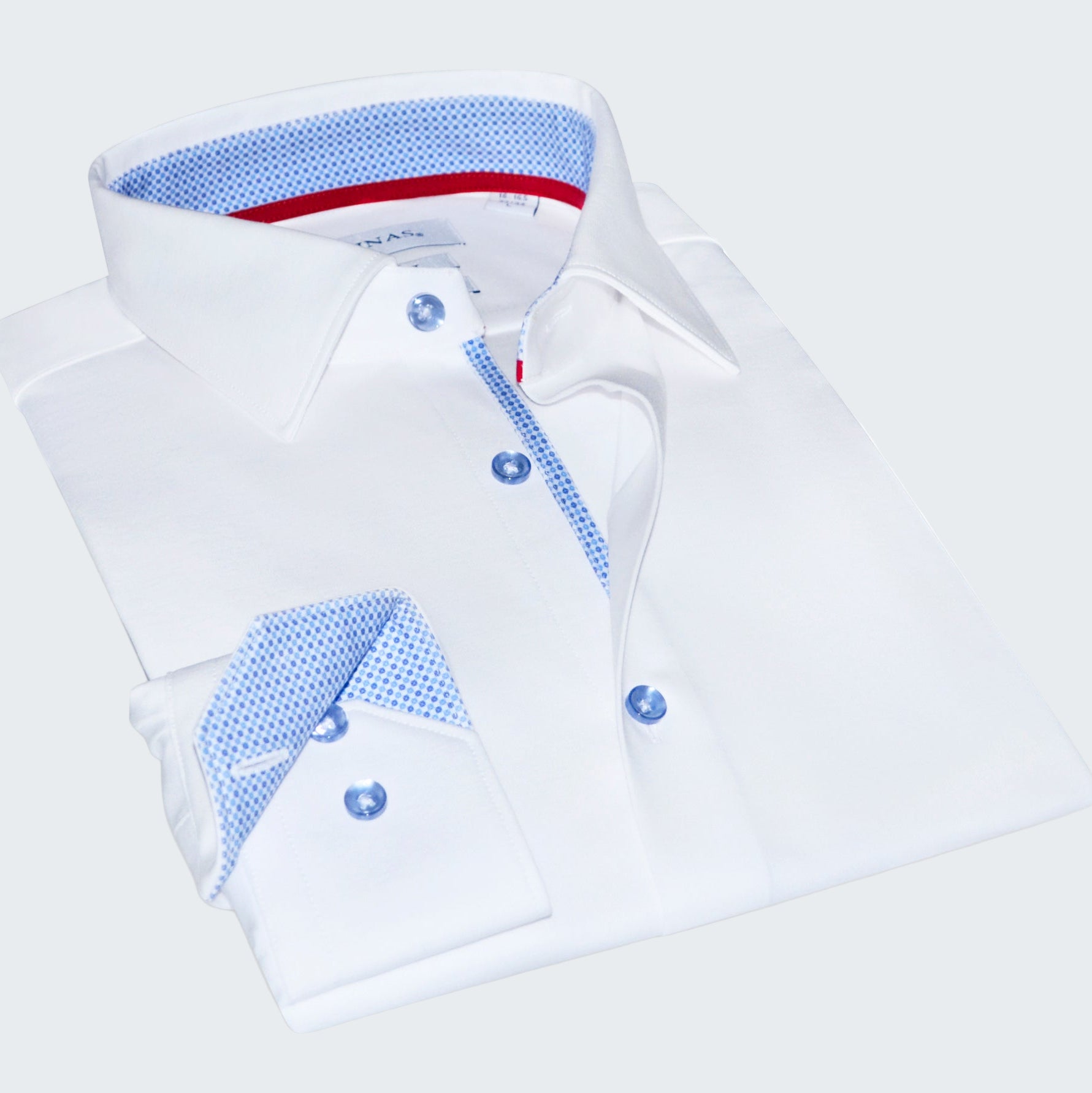 Folded white shirt with blue and red interior details on a white background