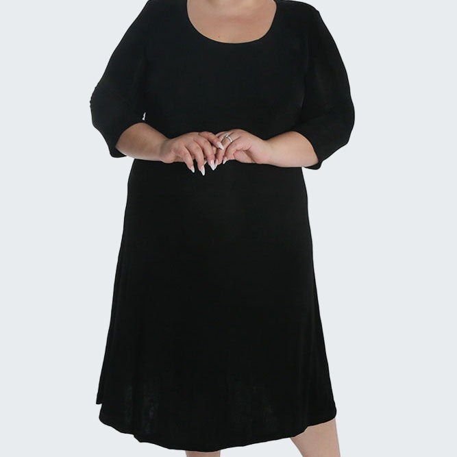 Woman wearing a black dress on a white background