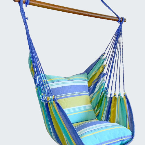 Striped hammock chair with blue, green, and yellow colors in a room setting.