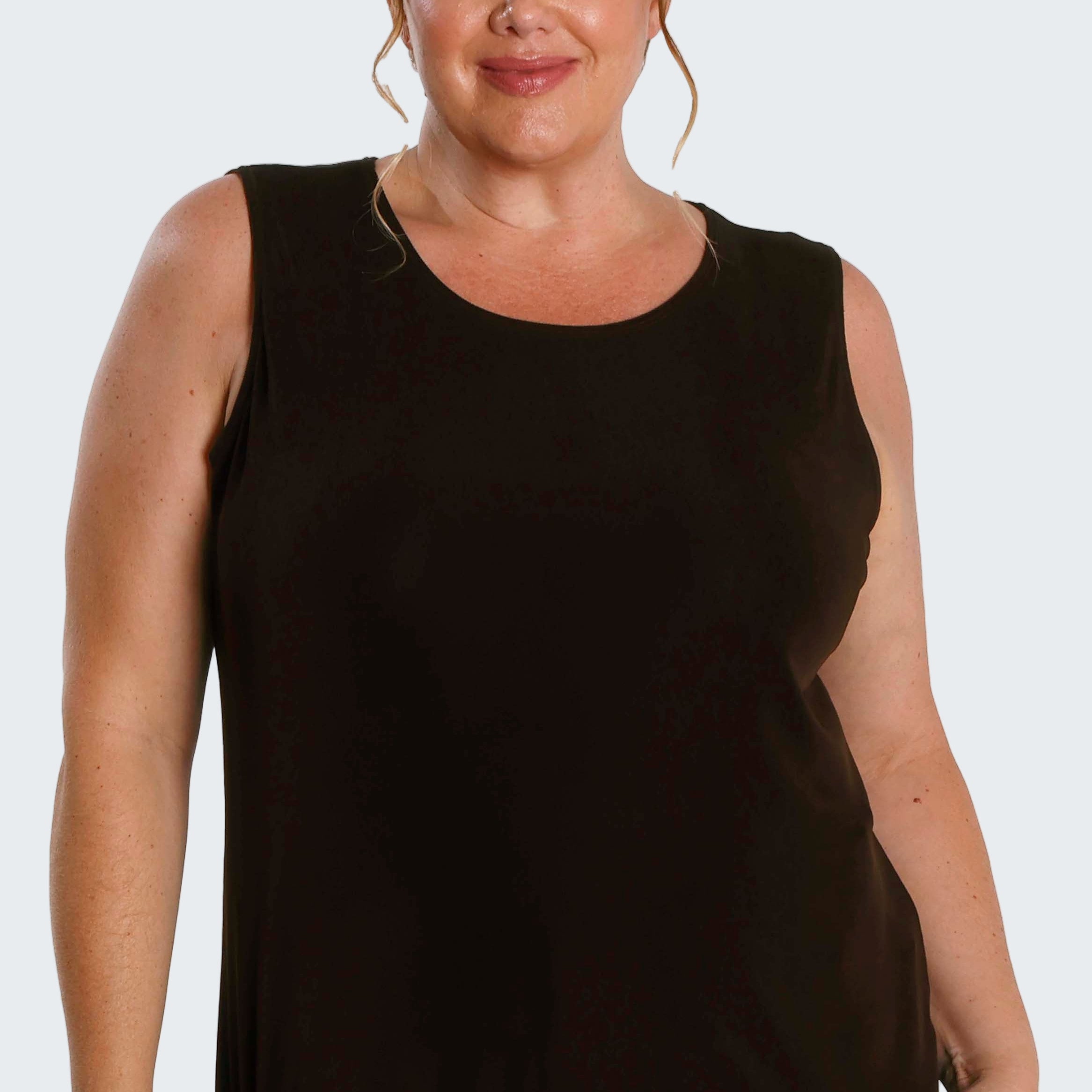 Woman wearing a black sleeveless top on a white background